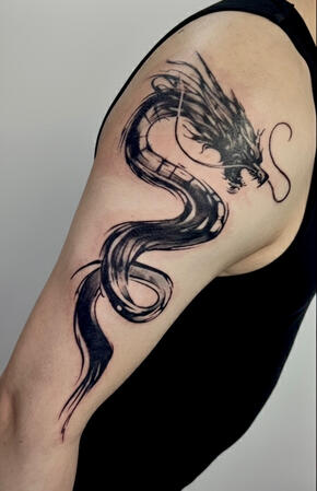 Blackwork dragon tattoo – upper arm